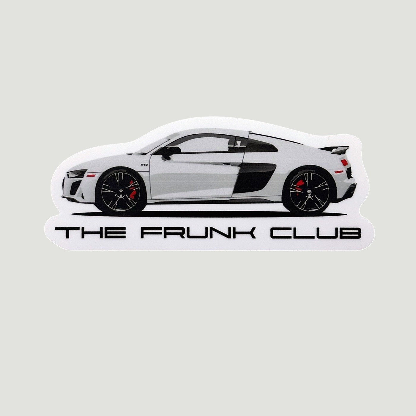 White Audi R8 side profile illustration with black accents, red brake calipers, and “THE FRUNK CLUB” text below.