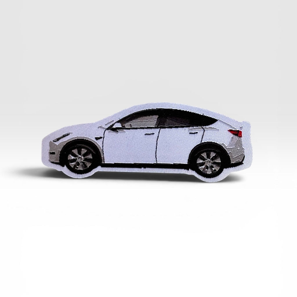 Side‑profile LEGO‑style model of a white Tesla‑inspired car displayed against a plain background.