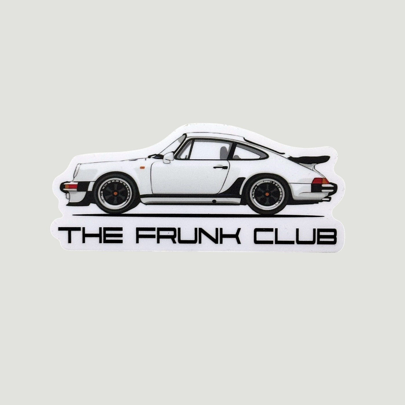 Die‑cut sticker of a white Porsche 930 side profile with black wheels and “THE FRUNK CLUB” text beneath.