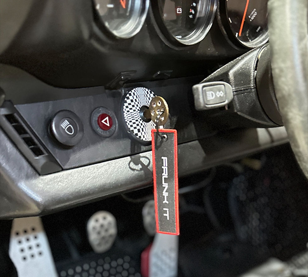 Thumbnail: Key tag displayed inside a car interior with dashboard controls visible, highlighting the red border and silver embroidered l