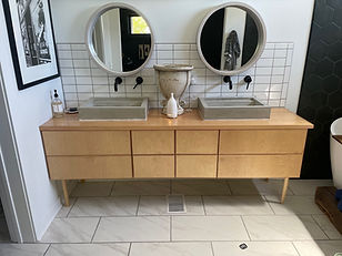 Bohemian Farmhouse Modern sink console with concrete vessel sinks.