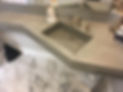 Floating concrete vanity top with integrated square sink. At boutique hotel in historic building. Built with angle to accommodate original to building post. Stricklan Hotel, Florence Alabama