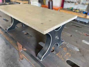 Concrete coffee table on fabricated steel legs