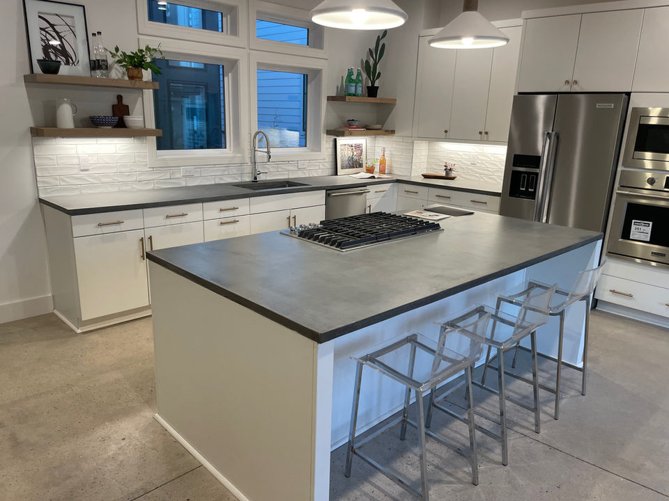 Gray concrete island and countertop. Modern Home.