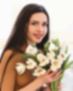 portrait-smiling-young-woman-holding-flower-bouquet_edited.jpg