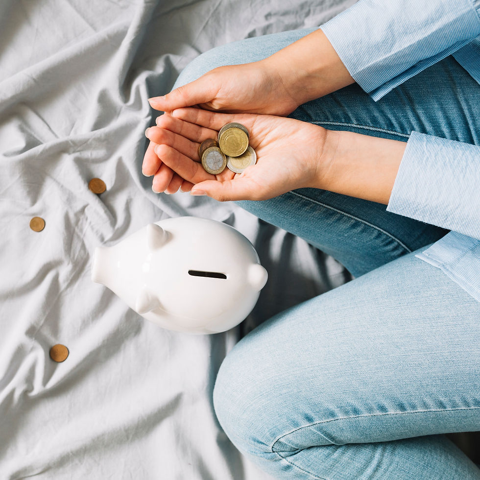 elevated-view-human-hand-with-coins-near-piggybank.jpg