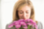 casual-businesswoman-smelling-flowers-office.jpg