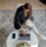 young-woman-using-laptop-making-notes-notebook-sitting-workplace-home-remote-work-top-v_ed