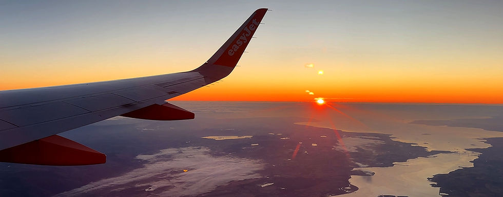 A sunrise from a plane window