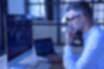 Professional analyzing market entry data on computer screens
