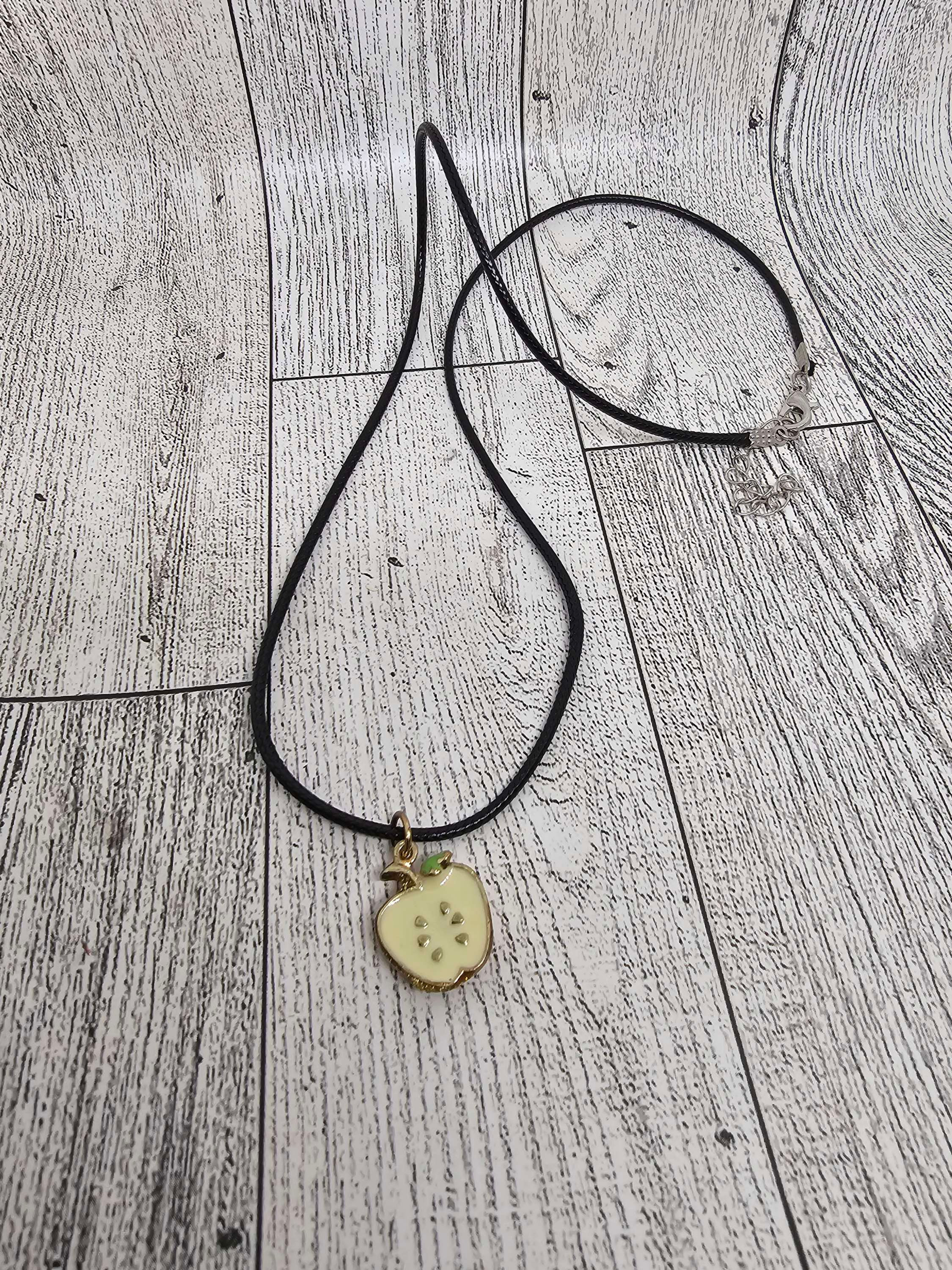 apple charm necklace shown out of package