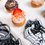 Thumbnail: Strawberry-topped mini donut on marble beside large black-and-white Skull Hand donut sticker.