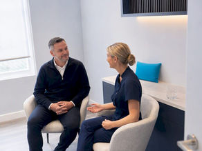 Patient discussing ear clinic appointment costs
