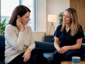 Patient discussing ear symptoms with clinician