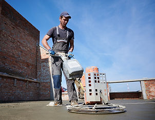 worker-using-power-trowel-machine-construction-site.jpg
