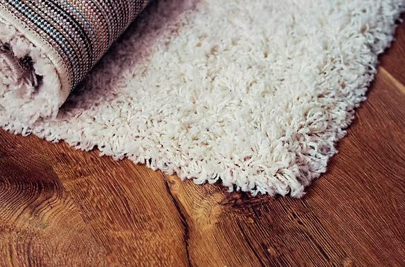 Fluffy white area rug after professional deep cleaning service, showcasing restored softness and freshness.