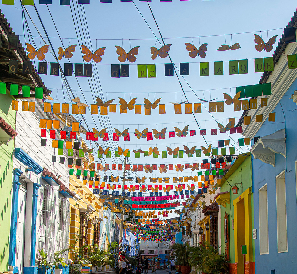 Rows of colorful flags on a colorful street.