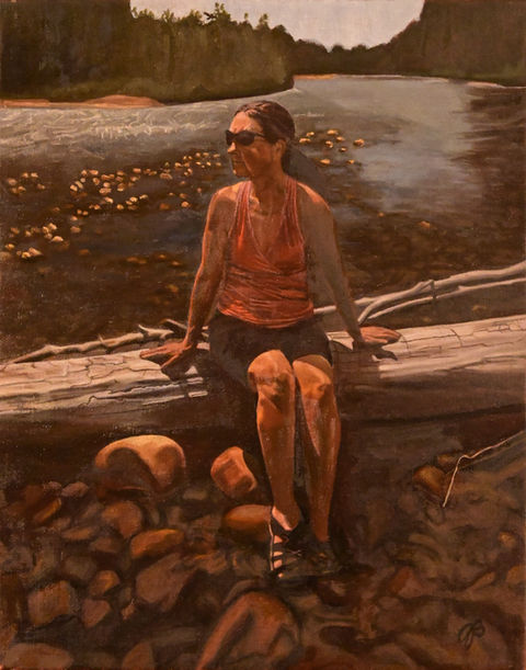 woman sitting on a log