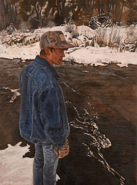man standing at snowy creek