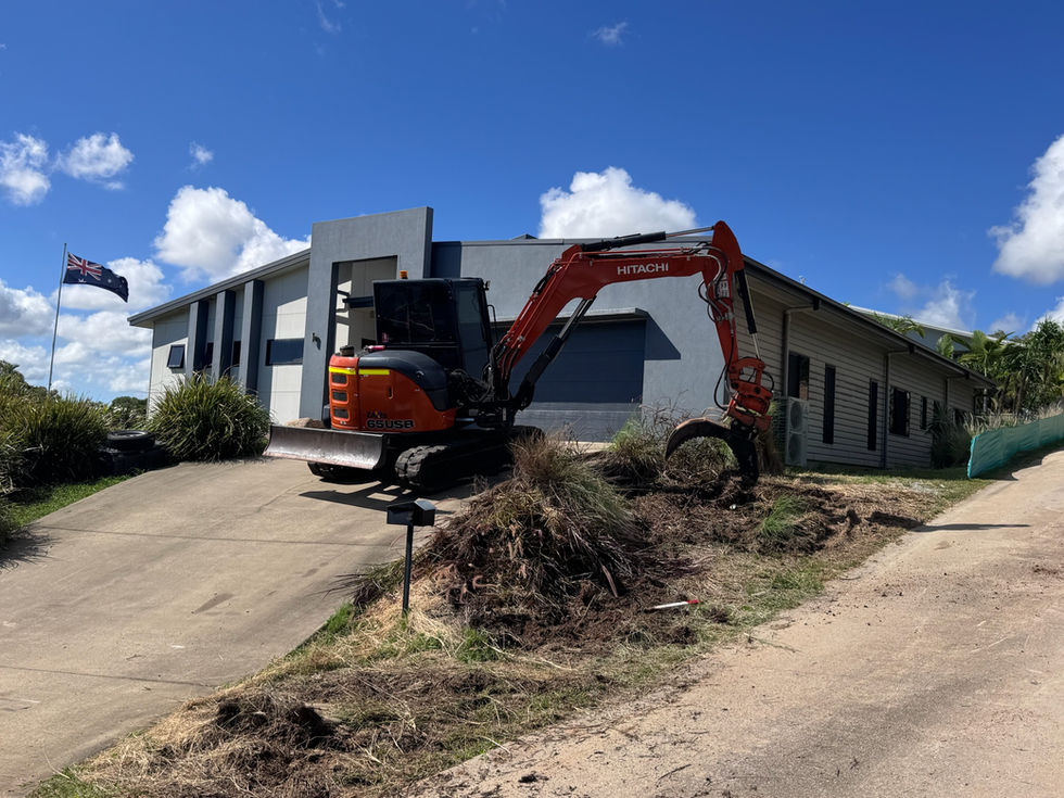 Excavator clearing green waste