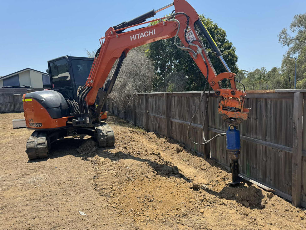 Hitachi excavator digging trench for retaining wall