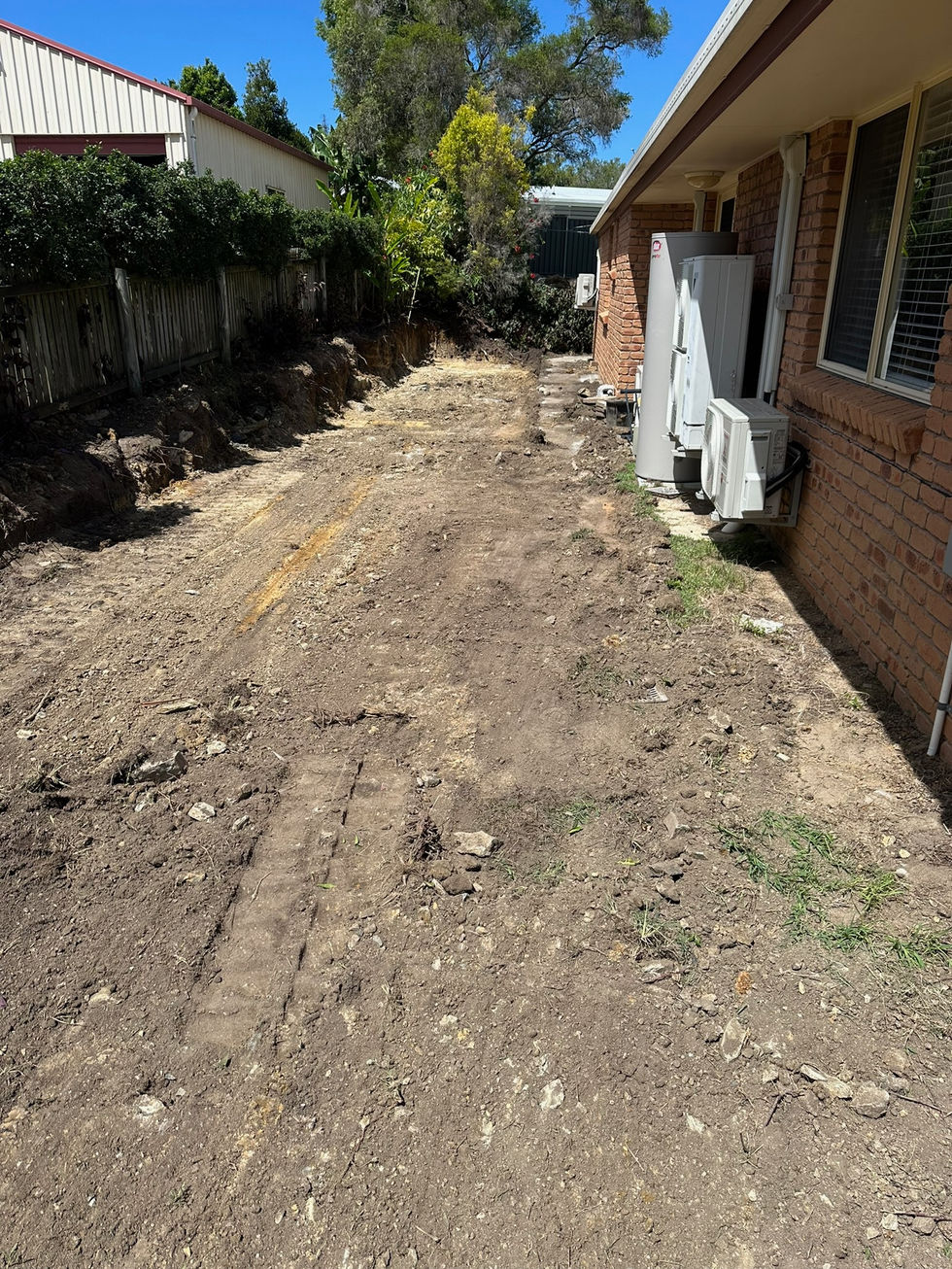 Cleared dirt area next to a house, site preparation