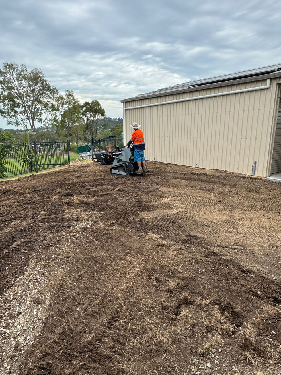 Person operating machine on dirt for site prep