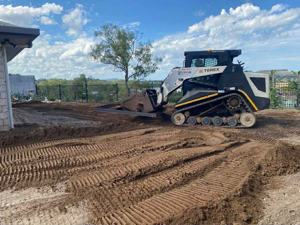 Skid steer leveling ground for landscaping
