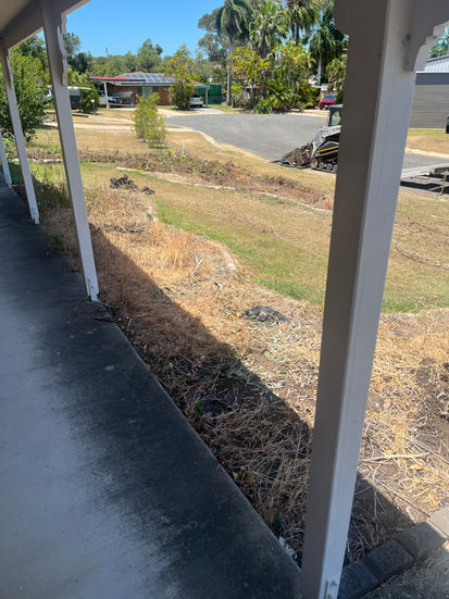 Dry, patchy lawn needing landscaping from a veranda
