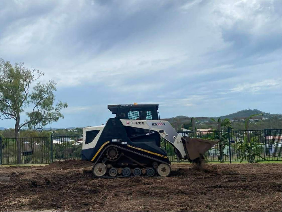 Skid steer loader preparing ground for landscaping