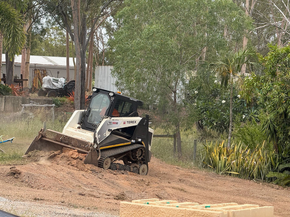 Skid steer moving soil for landscaping