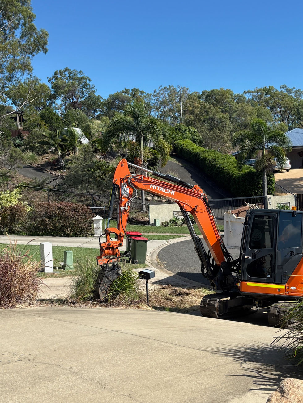 Excavator removing garden waste
