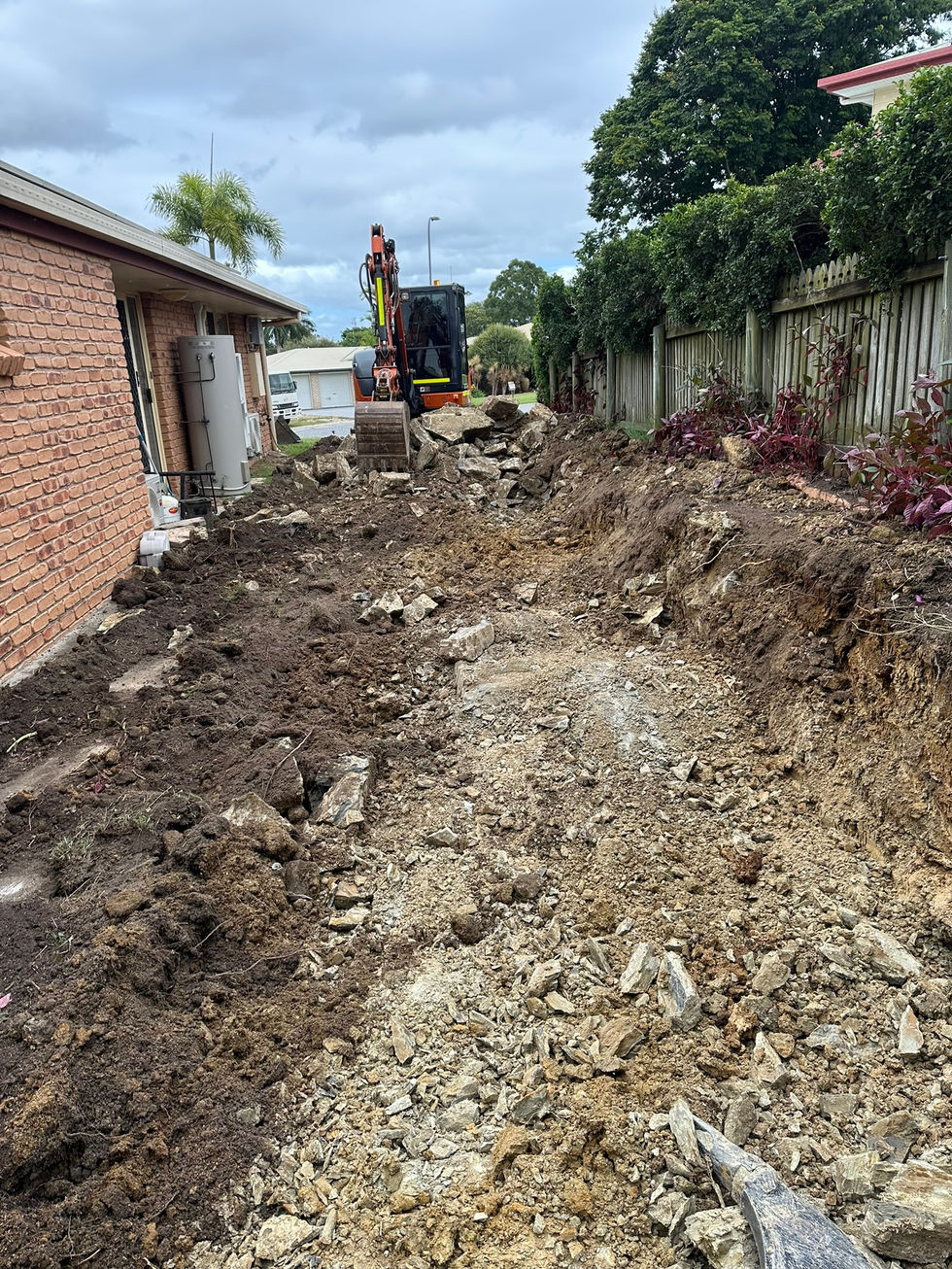 Excavator digging trench for site preparation