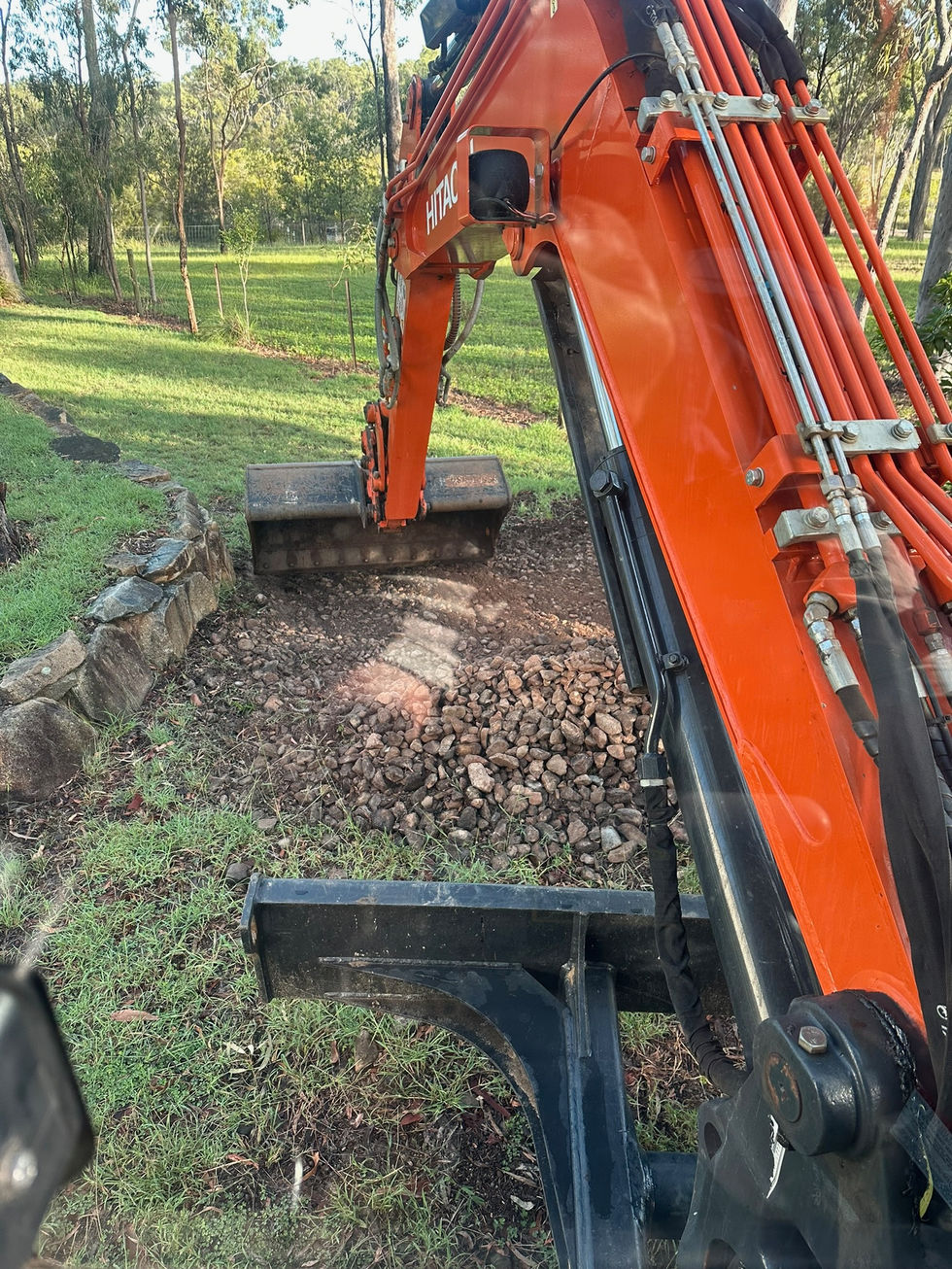 Orange excavator digging a trench