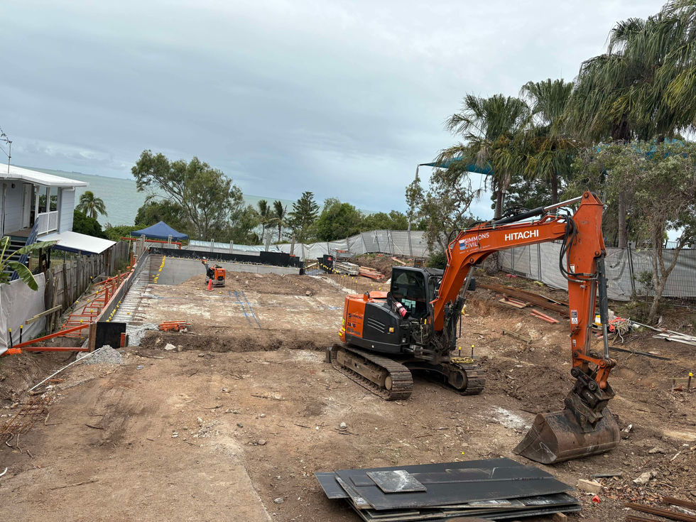 Construction site with excavator and trenches