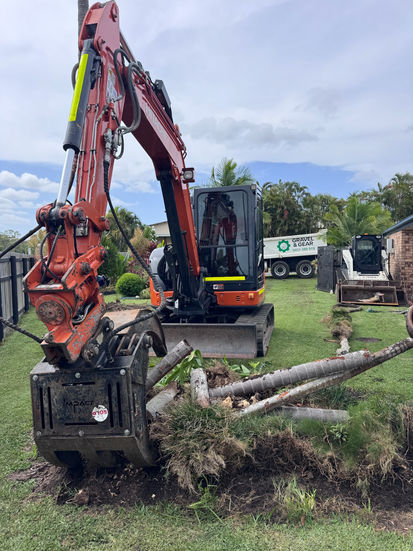 Excavator with grapple for green waste removal