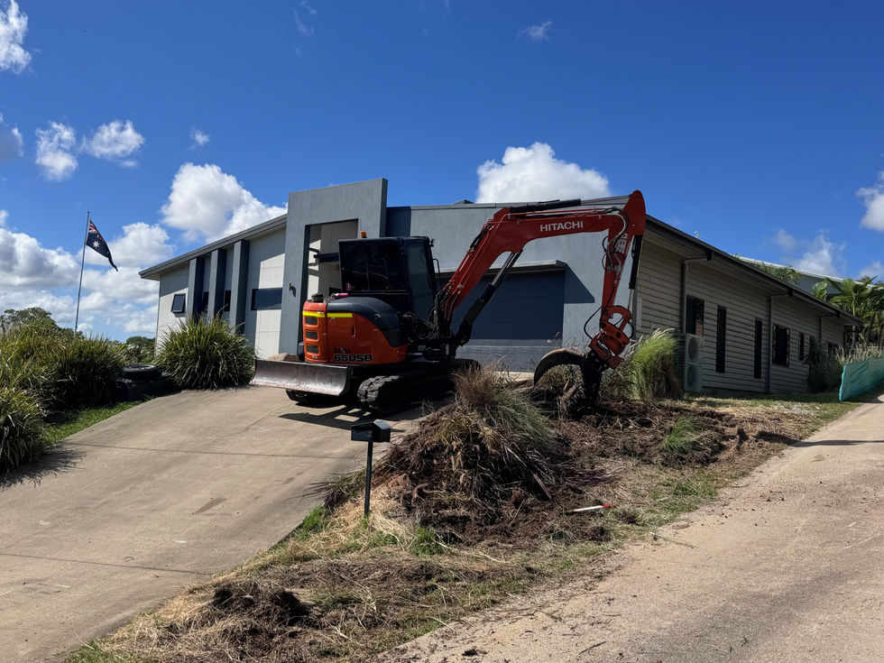 Mini excavator clearing garden waste