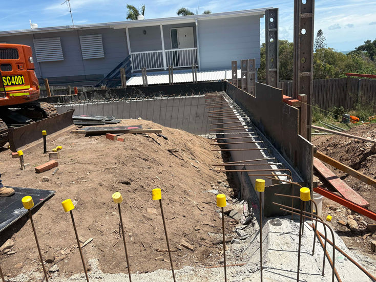 Retaining wall under construction with rebar