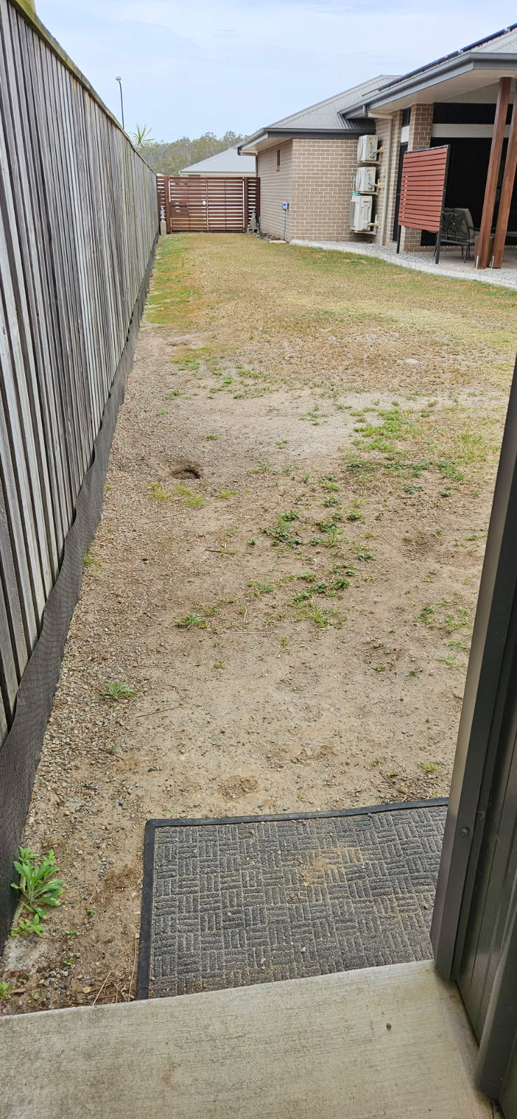 Patchy backyard lawn needing turfing or landscaping