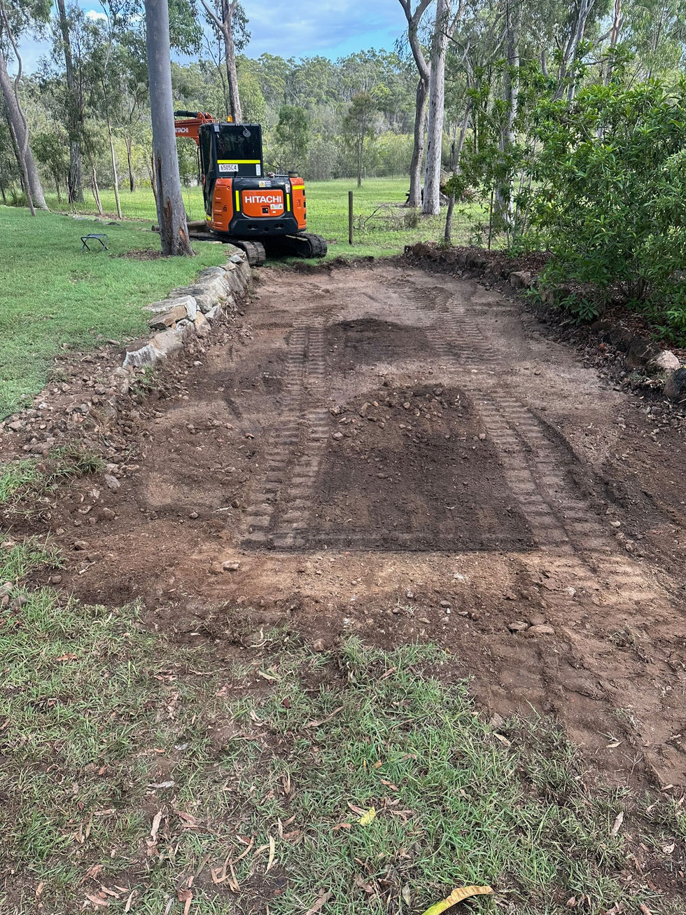 Newly excavated dirt path with an excavator