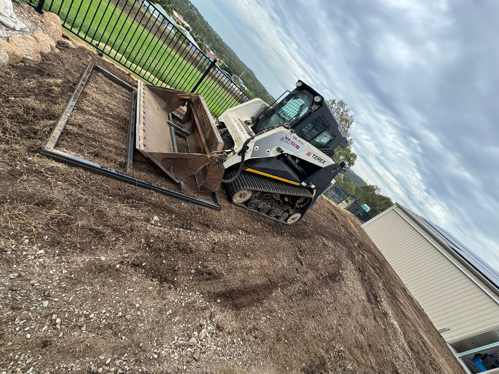 Skid steer preparing ground for landscaping