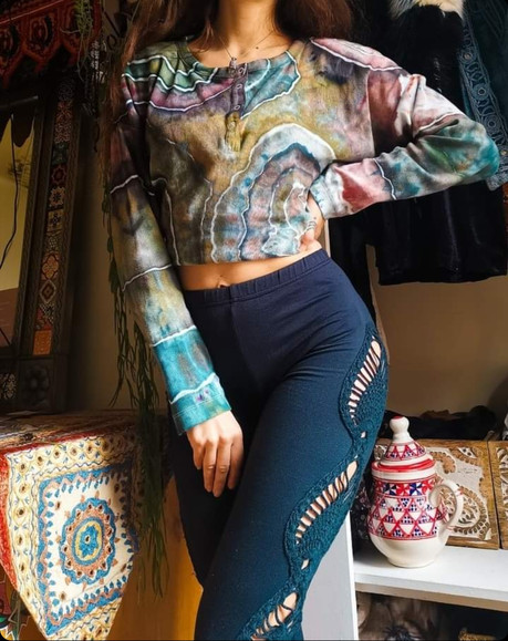 Female posing to show off her twisty tie dyed t-shirt in her living room