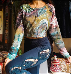 Female posing to show off her twisty tie dyed t-shirt in her living room