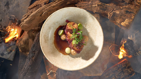 a plate of food with meat and vegetables on a table