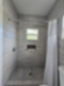 Modern Tiled Shower with Built-in Niche and Window