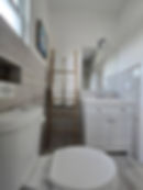 Modern Bathroom with Ladder Towel Rack and White Vanity