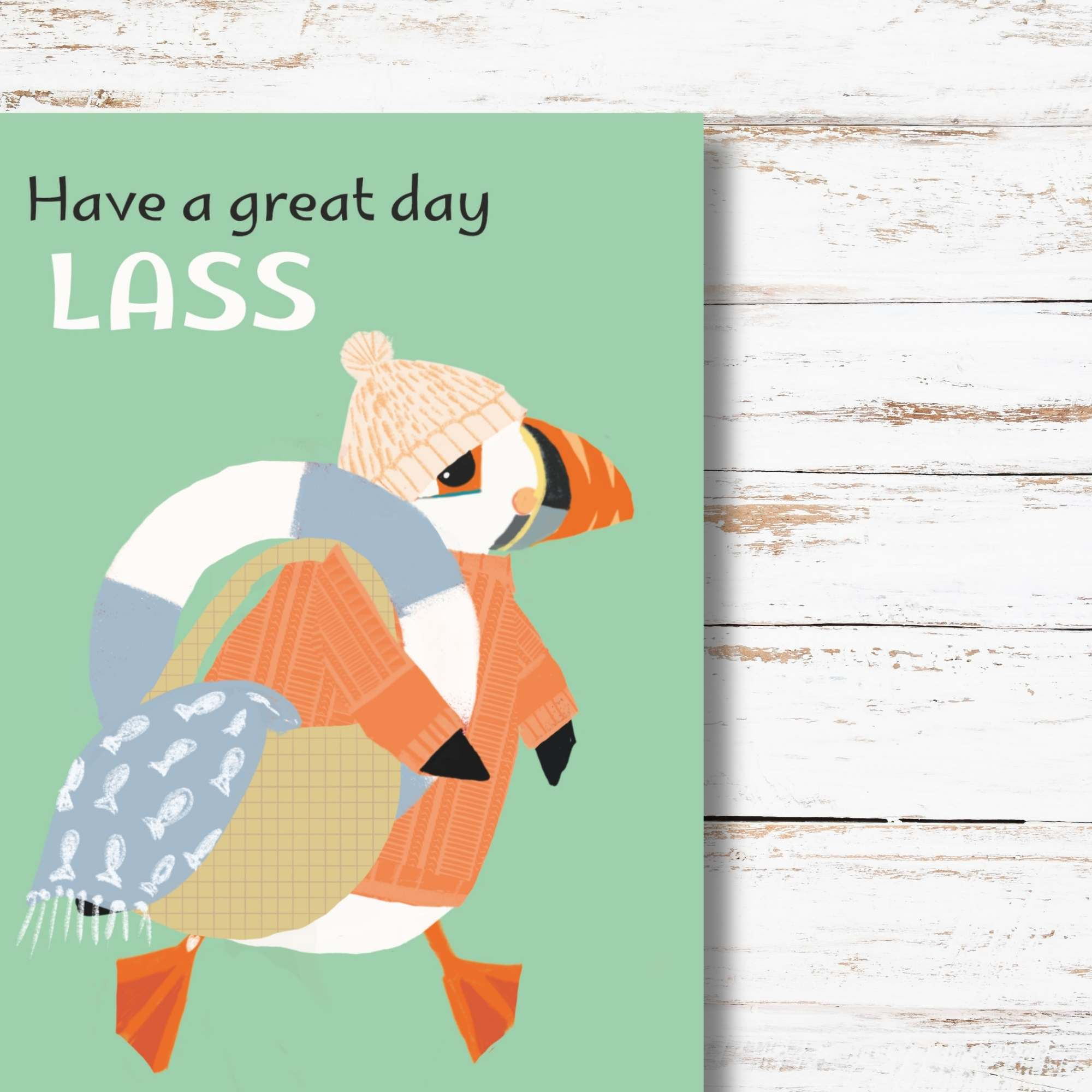 Puffin in peach jumper carrying basket with swim ring and towel