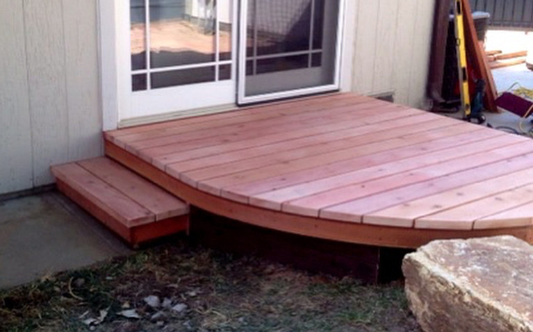 Backyard deck. Installed new sliding glass door to replace a window and built a small deck.jpg