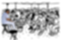 Man in white sitting at a small table against a black background.