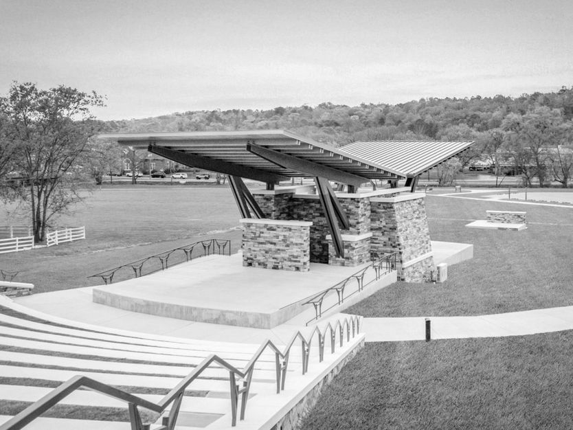 Rockmart Amphitheater with covered stage and open-air seating, showcasing completed outdoor performance venue and surrounding site improvements